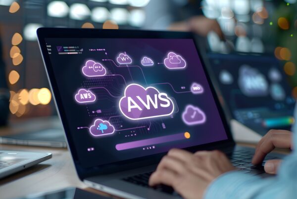 man working on a laptop with AWS web services holographic digital business hub device
